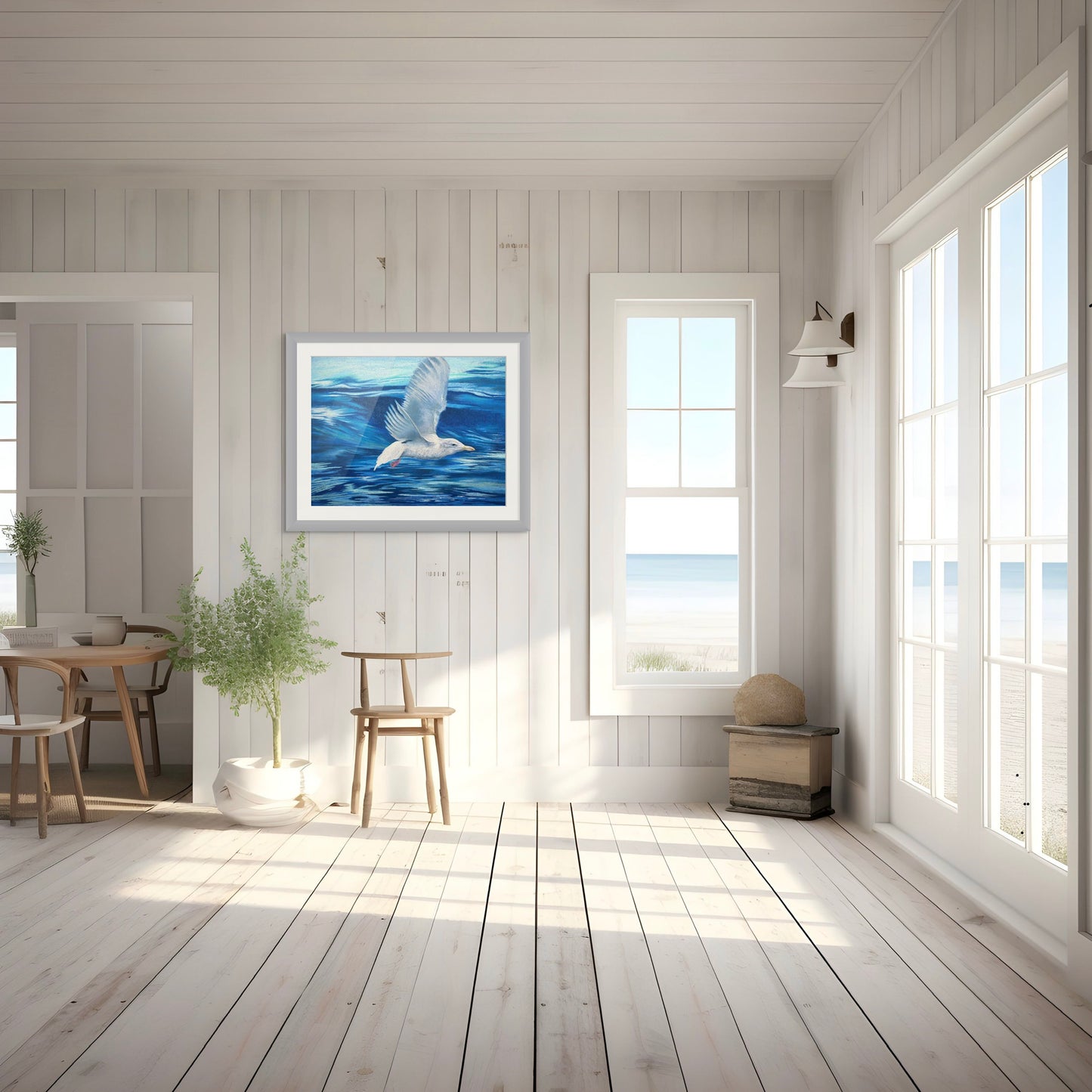 Room mockup of Crest of the Wave, a framed coastal bird painting by Georgia Edwards displayed in a light beach house interior.