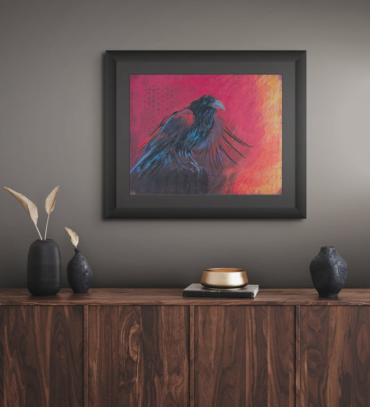 Room mockup of Raven’s Fire, a framed raven painting by Georgia Edwards displayed above a wooden cabinet in a moody modern interior.
